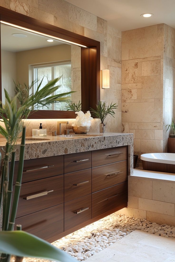 a bathroom with a tub, sink and mirror next to a potted palm tree