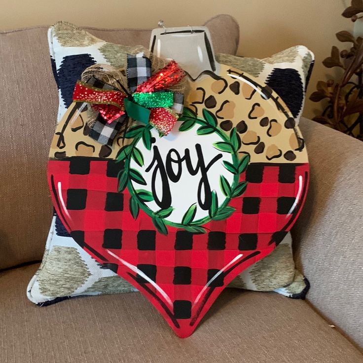 a pillow with the word joy on it and a bow at the top that reads, poshmark $ 50