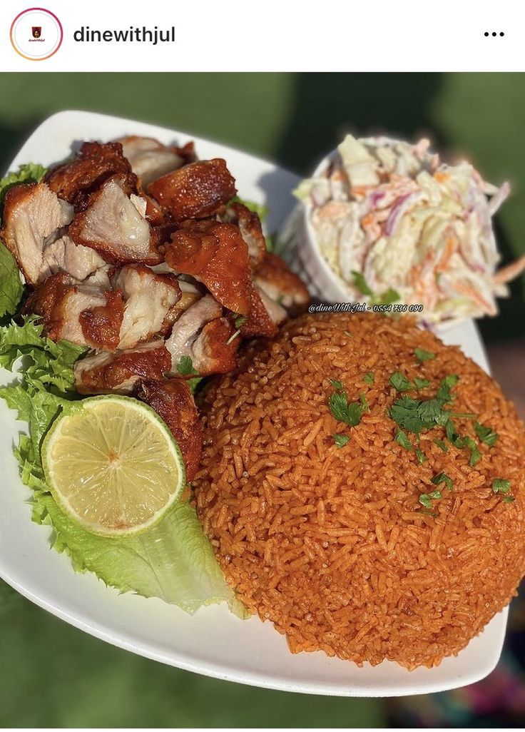 a plate with rice, meat and lettuce on it