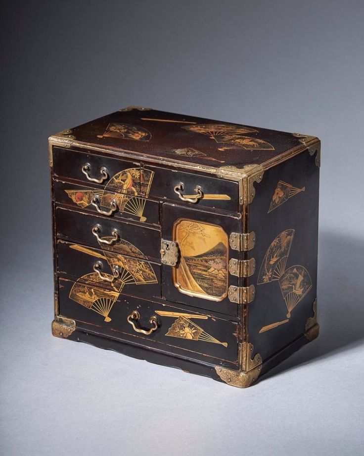 an antique black and gold decorated chest