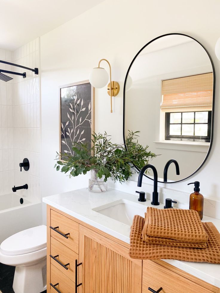 a bathroom with a sink, toilet and mirror