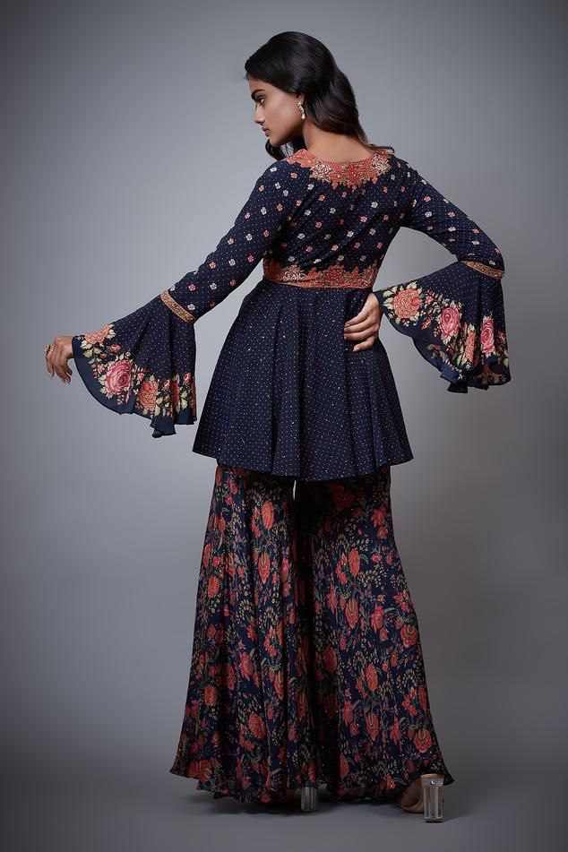 Navy blue tie-up top with floral embroidery and bell sleeves. Paired with printed, embroidered palazzo and blouse.
Component: 3
Pattern: Printed,Embroidered
Type Of Work: Floral
Neckline: Blouse: V neck
Sleeve Type: Top: Bell Sleeves
Fabric: Rayon Crepe
Color: Blue
Other Details: 
Tie-up top
Printed palazzo
Occasion: Sangeet - Aza Fashions Bohemian Blue Palazzo Set With Printed Motifs, Festivals Long Sleeve Palazzo Set With Floral Embroidery, Long Sleeve Floral Embroidery Palazzo Set For Festivals, Festival Long Sleeve Palazzo Set With Floral Embroidery, Festival Floral Embroidered Long Sleeve Palazzo Set, Blue Bohemian Sharara With Floral Print, Blue Long Sleeve Palazzo Set With Floral Embroidery, Traditional Blue Sets With Embroidered Sleeves, Bohemian Palazzo Set With Floral Embroidery For Festive Occasions