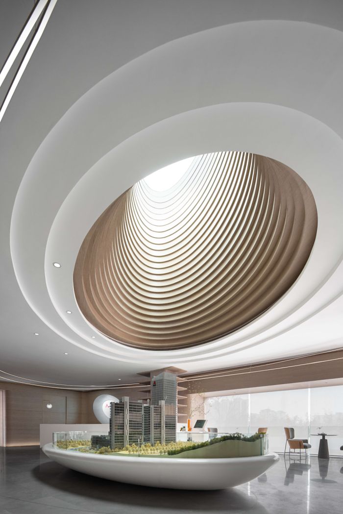 the interior of a modern building with an unusual ceiling and circular light fixture in the center