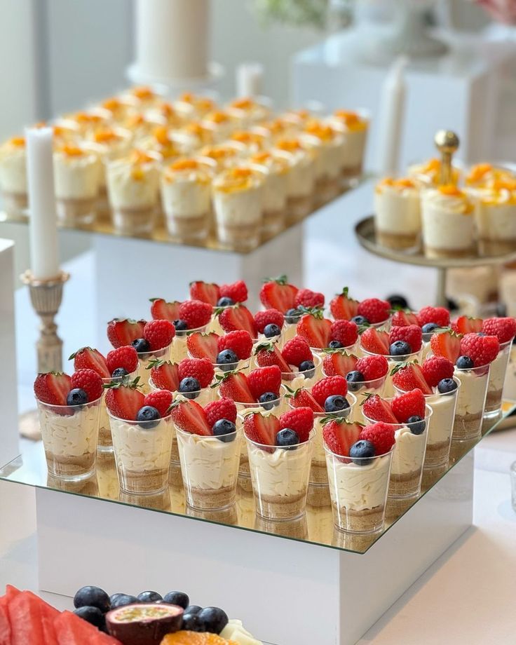 desserts are arranged in small cups and on display at a wedding or reception table