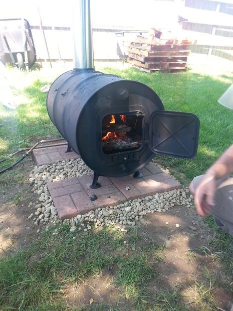 a person standing in front of an open fire pit