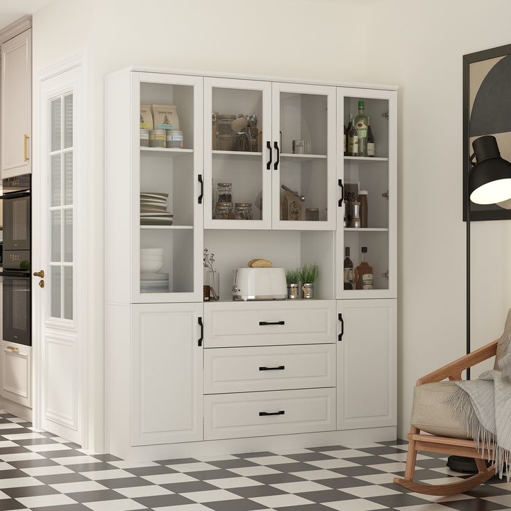 a white kitchen with black and white checkered flooring