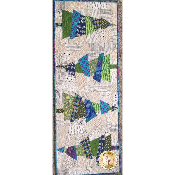 a quilted wall hanging with many different colors and designs on it's sides