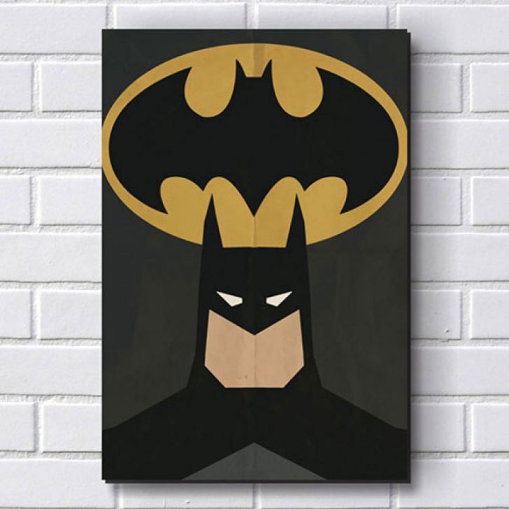 a batman poster hanging on the wall next to a white brick wall with a black background