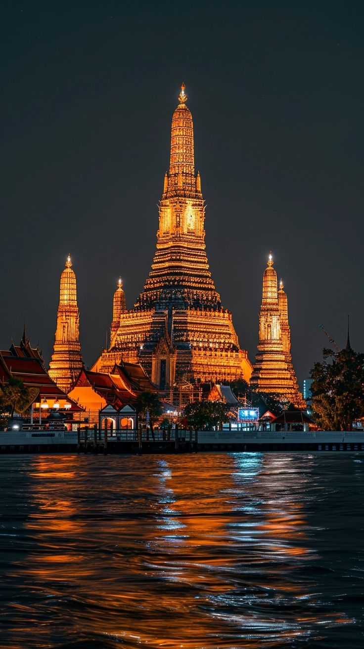 an image of a city at night with lights on it's spires and buildings