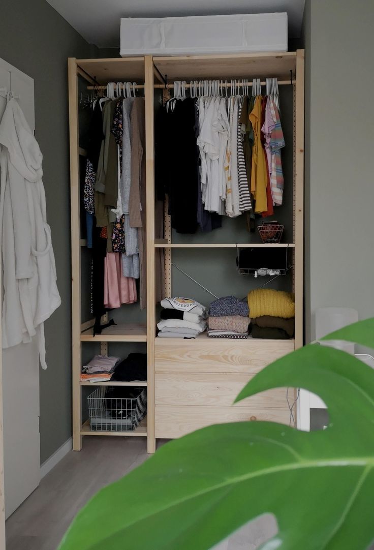 an open closet with clothes and other items