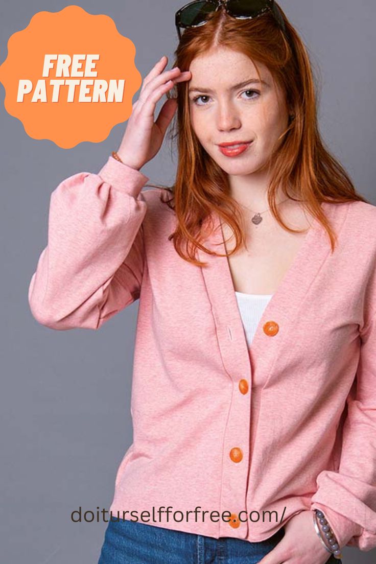 a woman with red hair wearing sunglasses and a pink cardigan sweater over her shoulders