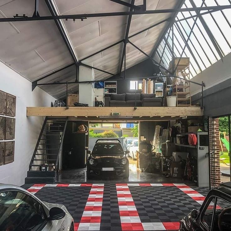 a car is parked in the garage with its door open and it's stairs up