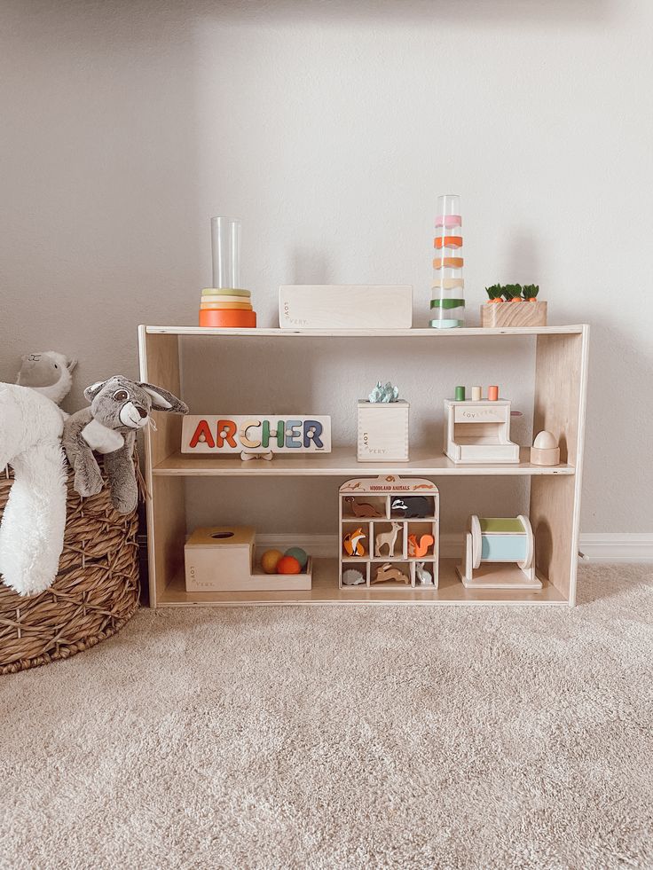 a wooden shelf with toys on top of it in a child's playroom