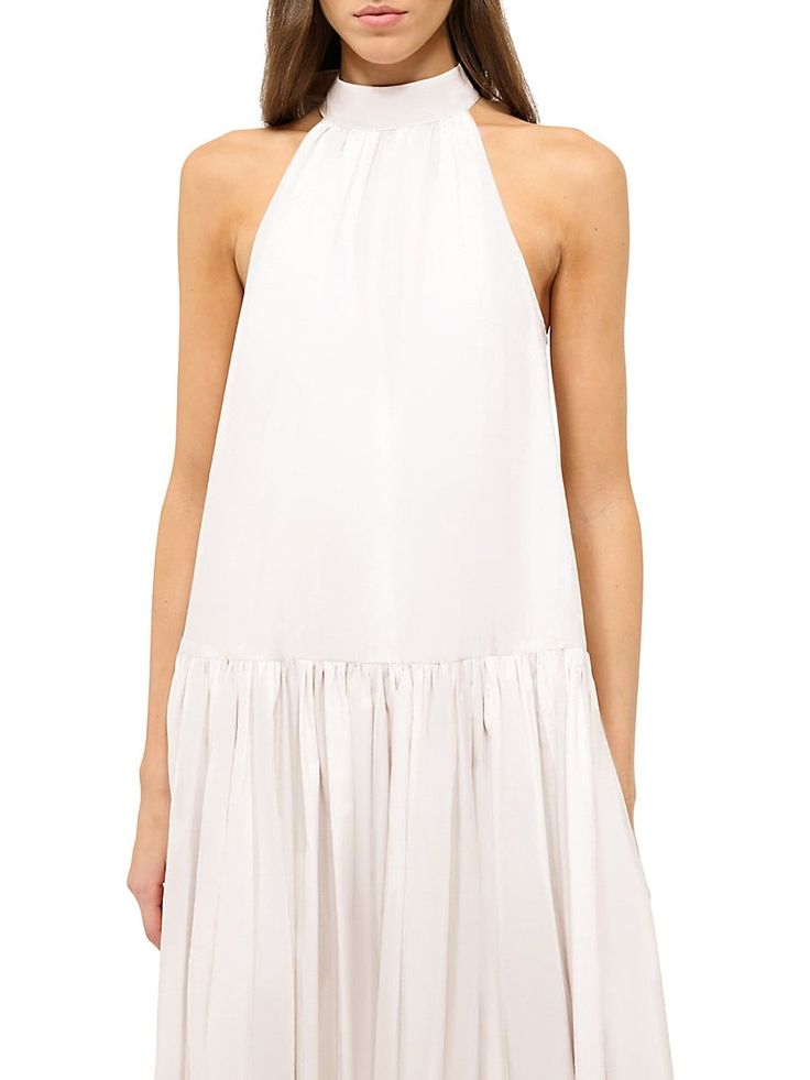 "Find STAUD Marlowe Poplin Halter Maxi Dress on Editorialist. Fashioned from cotton poplin, Staud's Marlowe maxi dress features a halter neck, drop waist, and single-tiered skirt. This sleeveless piece is finished with a cut-out back and self-tie bow closure. Halterneck Sleeveless Drop waist Back self-tie closure 98% cotton/2% spandex Dry clean Imported SIZE & FIT Model measurements: 5'10\" tall Model is wearing a US size Small. Staud. Color: White. Size: XS."