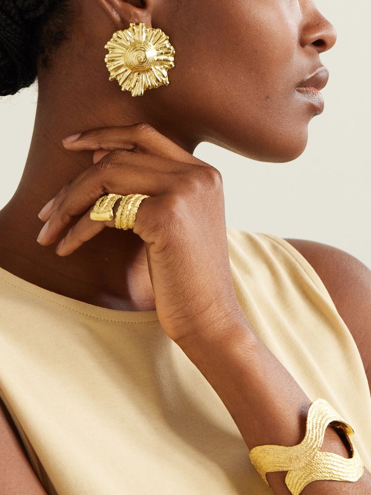 Inspired by their Greek heritage, Alexia and Stalo Karides founded The Ysso to "showcase a harmonious fusion of the past and present". Named after the Ancient Greek God 'Ilios', these earrings have been hand-carved in Athens from gold-plated metal in the form of the sun. Their statement size and polished finish will bring a radiant glow to your complexion. Gold Plated Fusion Style Earrings, Luxury Gold Earrings With Polished Finish, Opulent Gold Jewelry Gift, Fusion Style Gold Plated Gold Earrings, Fusion Style Pierced Jewelry For Formal Occasions, Fusion Style Gold Anniversary Jewelry, Luxury Gold Brass Jewelry, Elegant 22k Gold-tone Jewelry, Exquisite Gold Rings For Evening