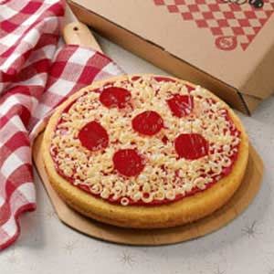 a pizza sitting on top of a wooden cutting board next to a box of pizza