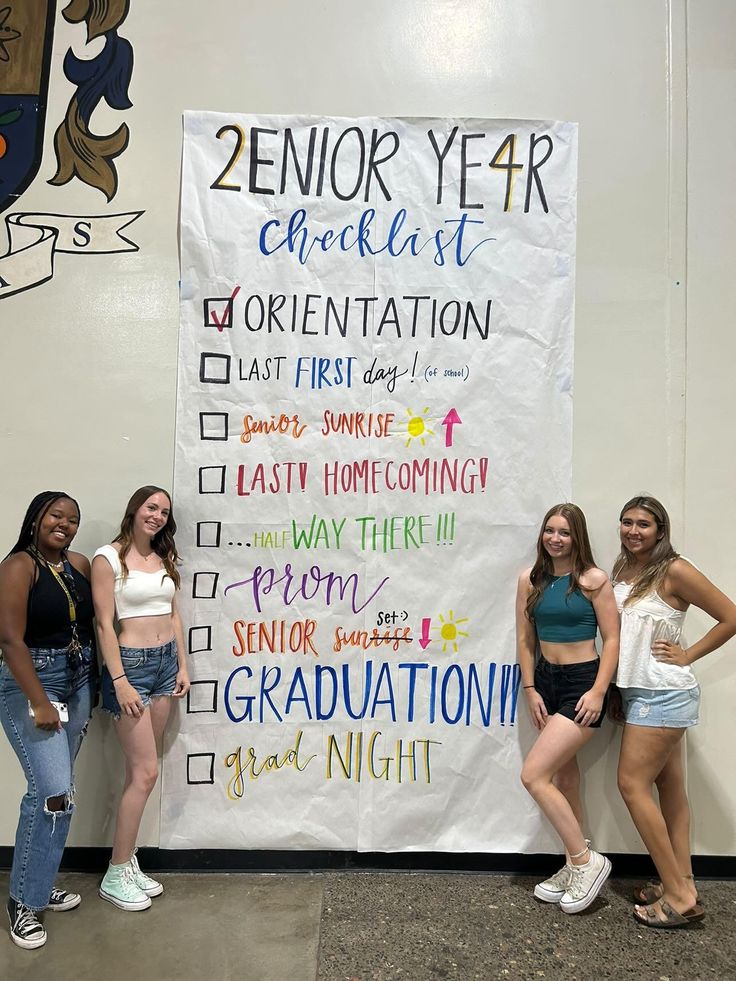 three girls are standing in front of a sign