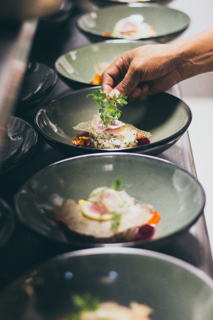 several plates with food on them are lined up