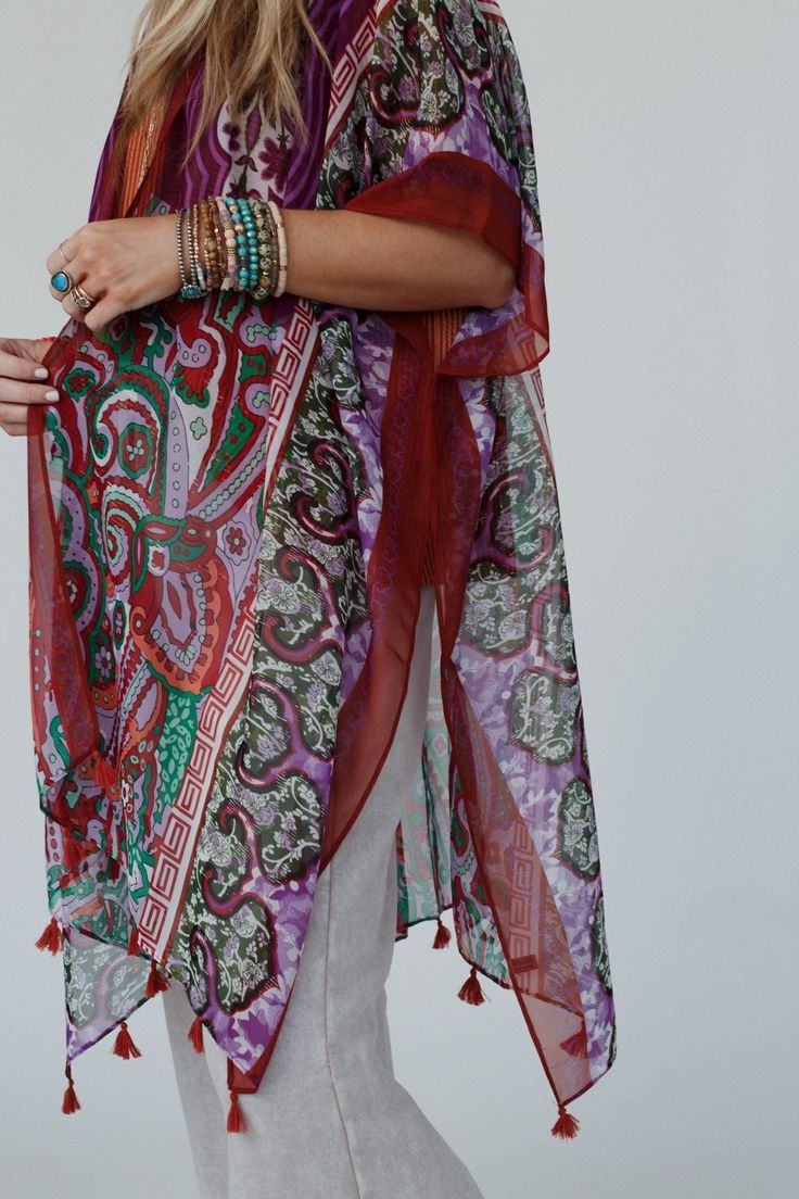 You'll add a stunning addition to your boho wardrobe with our Tabitha Floral Kimono, sure to become a cherished piece in your collection, adding a touch of bohemian glamour to every occasion! You'll love layering with this eye-catching kimono becasue it features: Lightweight, woven, slightly sheer fabric with a so pretty print throughout Relaxed and loose kimono silhouette Classic open front closure Loose kimono style sleeves and side slits created by single side seams So cute tassel details alo Traditional Summer Kaftan With Dupatta, Red One-size Kimono For Festivals, Multicolor Spring Kaftan With Back Tassel Tie-up, Bohemian Festive Kaftan, Bohemian Kaftan With Dupatta For Festivals, Multicolor Kaftan With Back Tassel Tie-up For Summer, Multicolor Boho Print Kimono For Festival, Free Size Bohemian Kimono For Festivals, Traditional Kaftan With Back Tassel Tie-up For Festivals