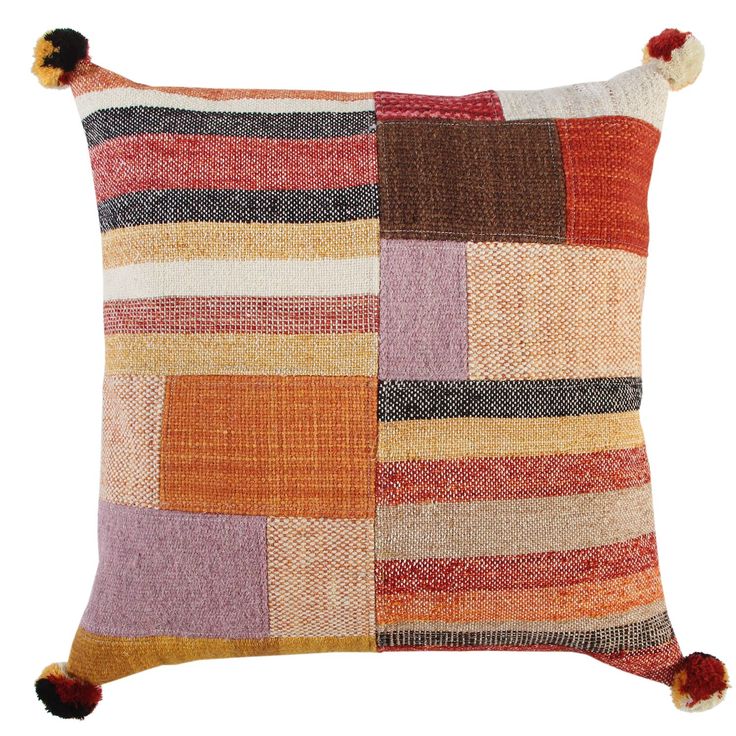 a multicolored pillow with pom - poms on the front and sides