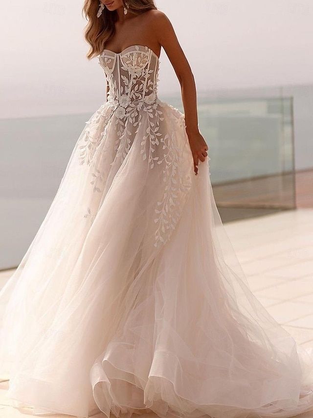 a woman in a wedding dress standing on a balcony