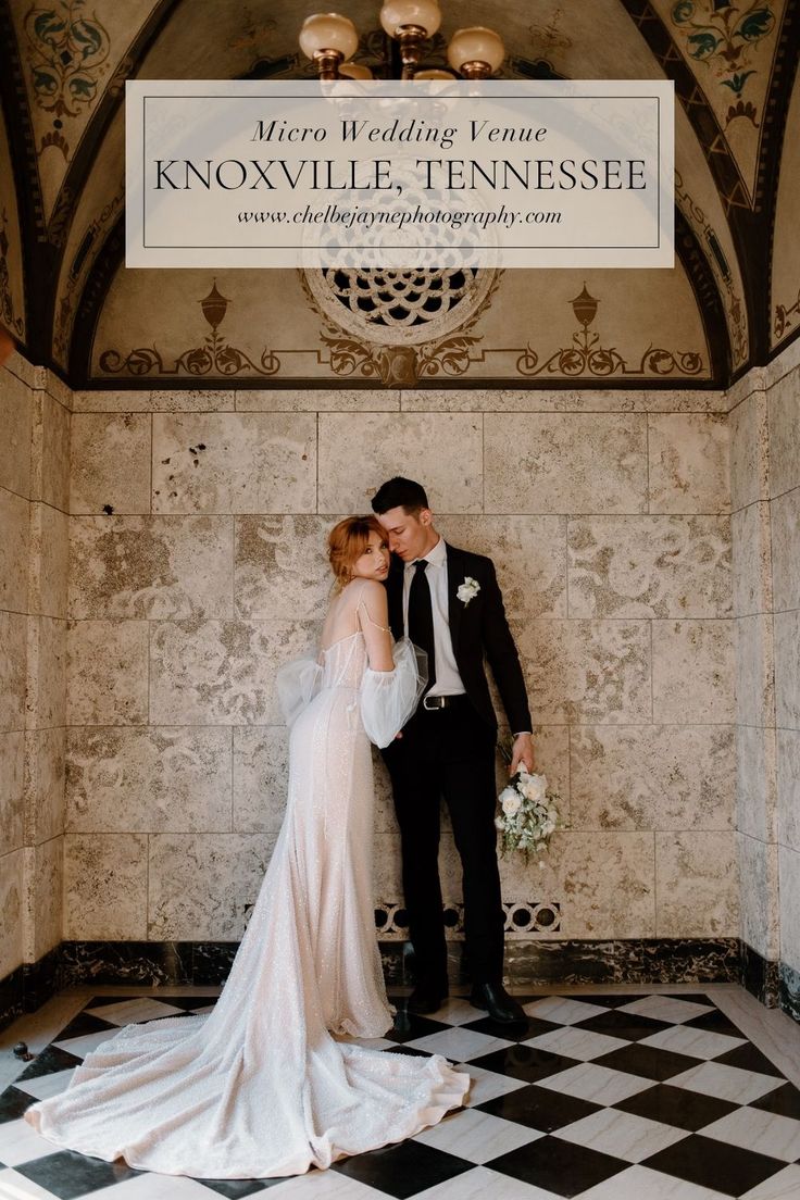 a bride and groom standing in front of a sign