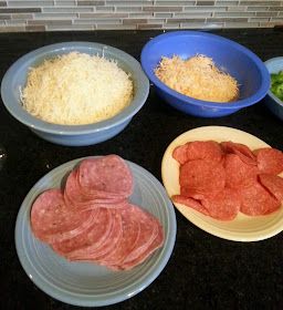 four bowls with different types of food in them sitting on a counter top next to each other