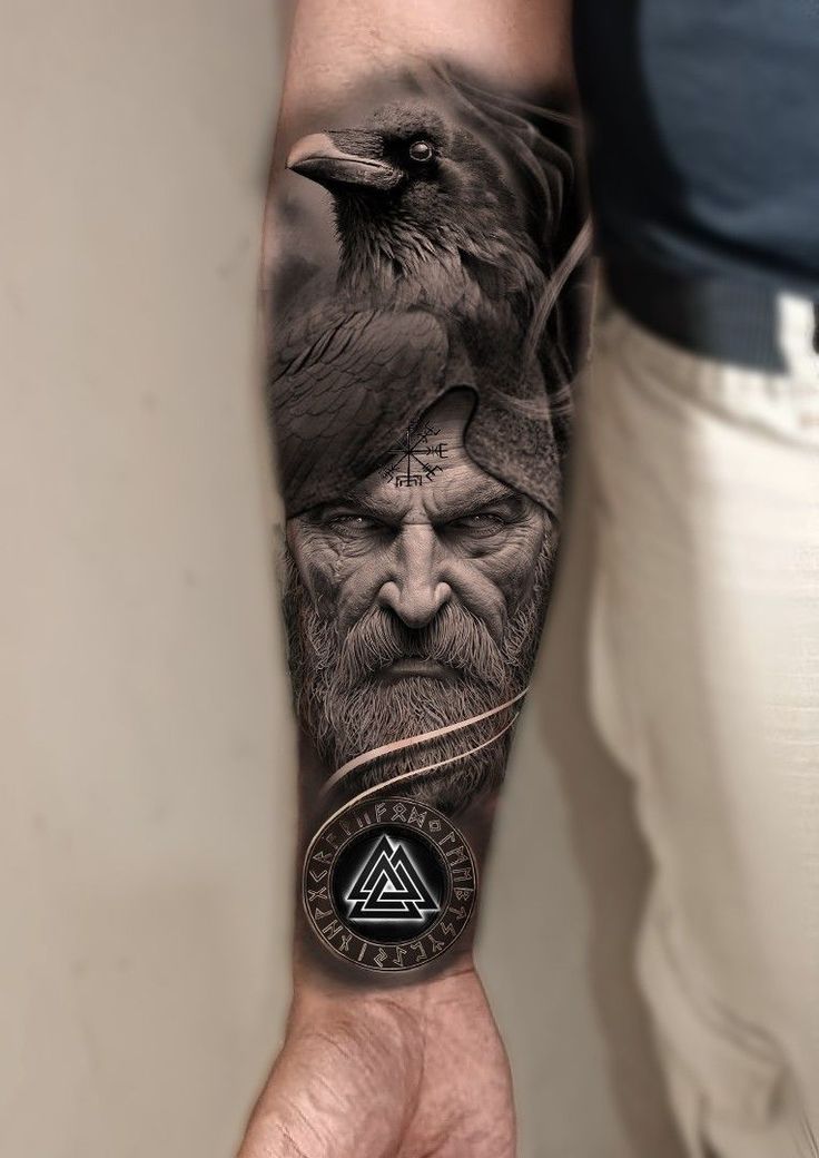 a man's arm with a black and grey tattoo on it, depicting an old man