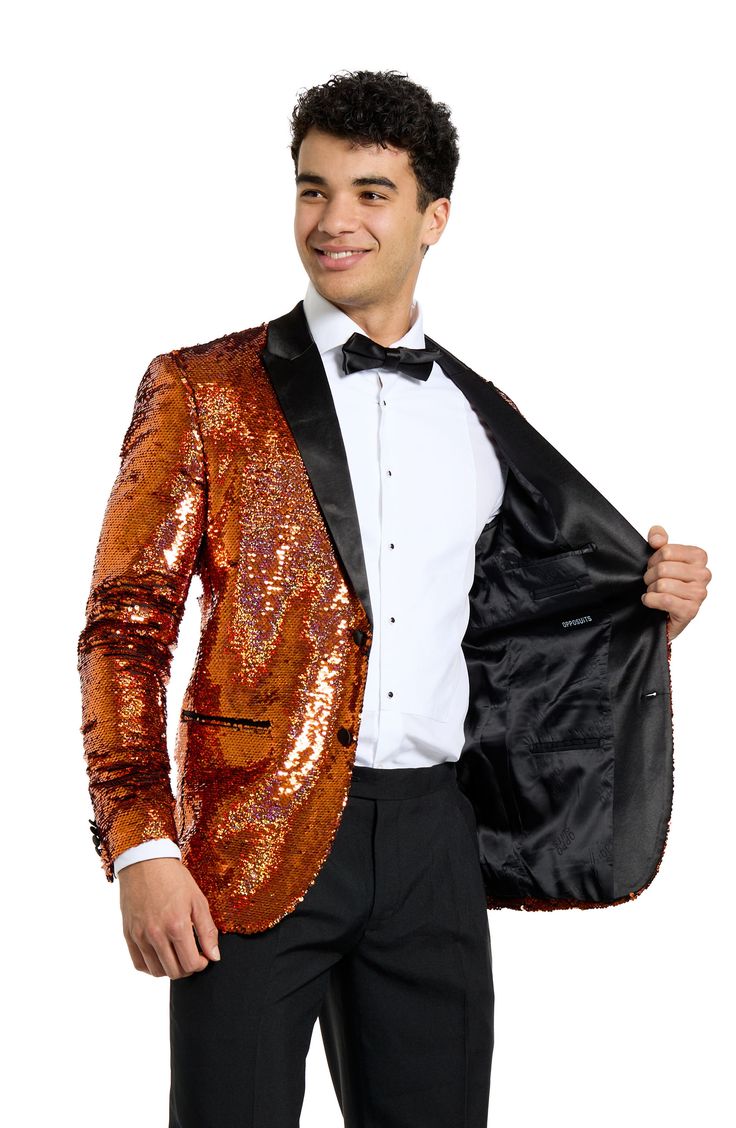 Drenched in golden sequins and finished with satin lapels, the jacket of this entrance-making tuxedo pairs with pleated black trousers and a coordinating bow tie to finish the standout look. Jacket has peaked lapels; four-button cuffs; chest pocket; welt pockets; interior pockets; side vents Trousers have zip fly with button-tab closure; slant pockets; back pockets Jacket is lined Unhemmed 100% polyester Machine wash, line dry Imported Fitted Sequined Suits For Parties, Fitted Party Outerwear With Contrast Sequin, Festive Tailored Blazer For Evening, Glamorous Sequined Suits For Night Out, Party Suits With Sequins, Luxury Satin Blazer For Party, Sequin Party Suits, Sequin Party Suits For Party Season, Luxury Tailored Party Suits