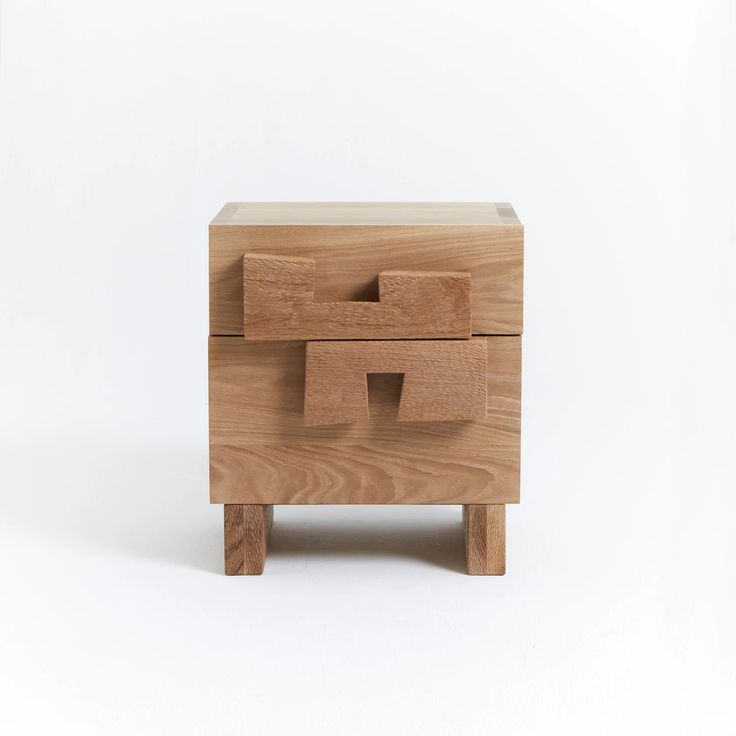 a wooden box sitting on top of a white surface