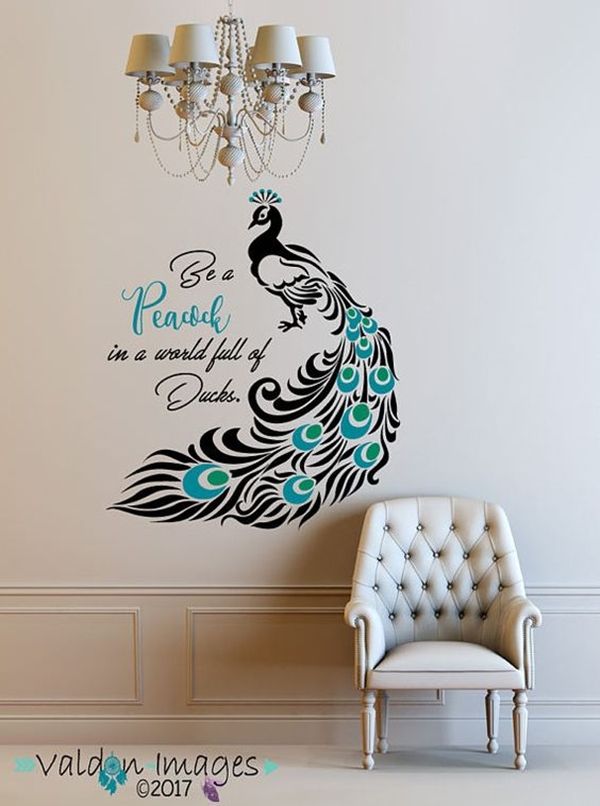 the peacock wall decal is next to a chair