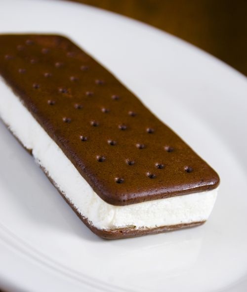 an ice cream and chocolate dessert on a white plate