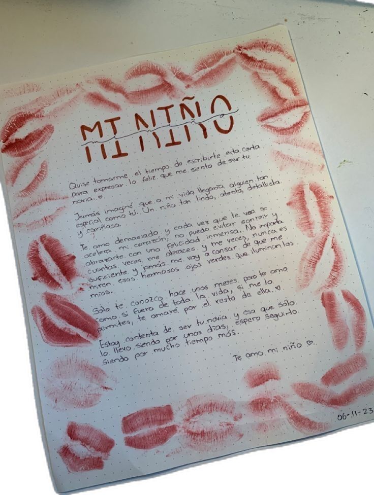 an open notebook with writing on it that has red lipstick imprints all over the page