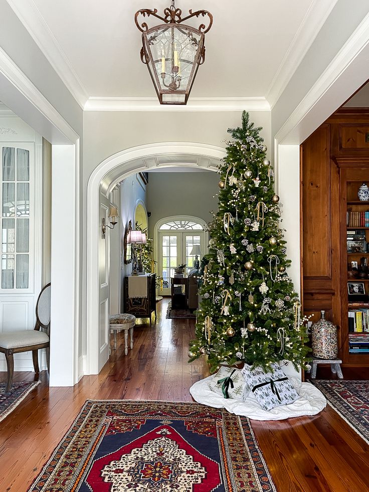 a christmas tree in the middle of a hallway