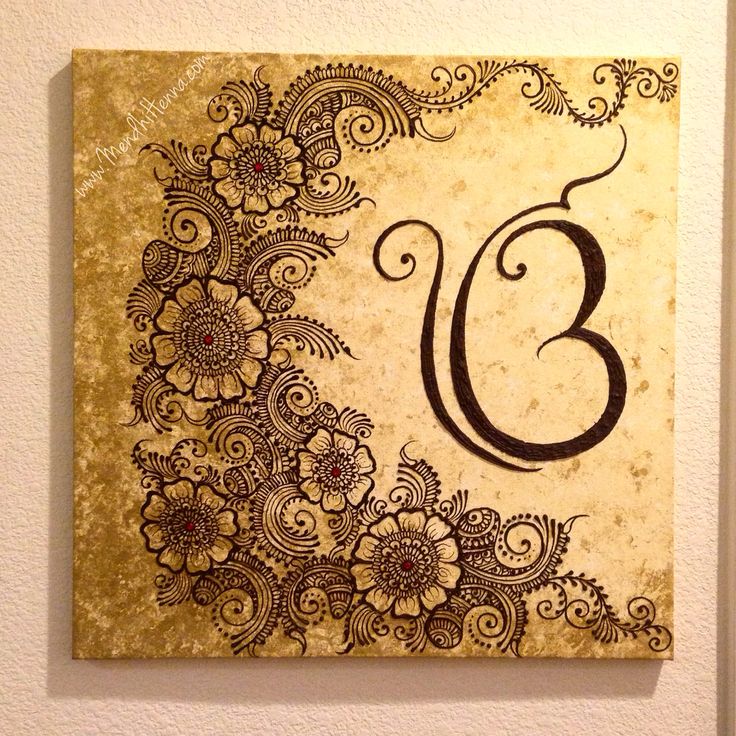 the number thirteen is decorated with flowers and swirls in black on a beige background