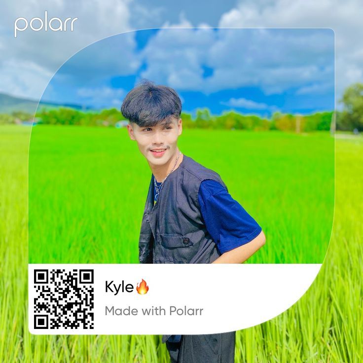 a boy standing in the middle of a field with a qr code on it