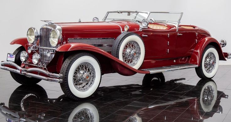 an old model red car is on display