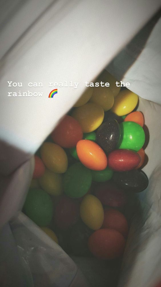 there is a bag full of jelly beans in the photo and it says, you can really taste the rainbow