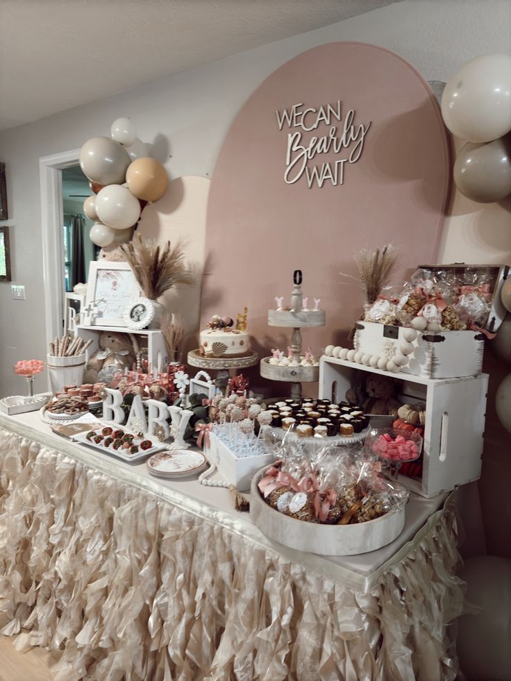 the dessert table is set up with balloons