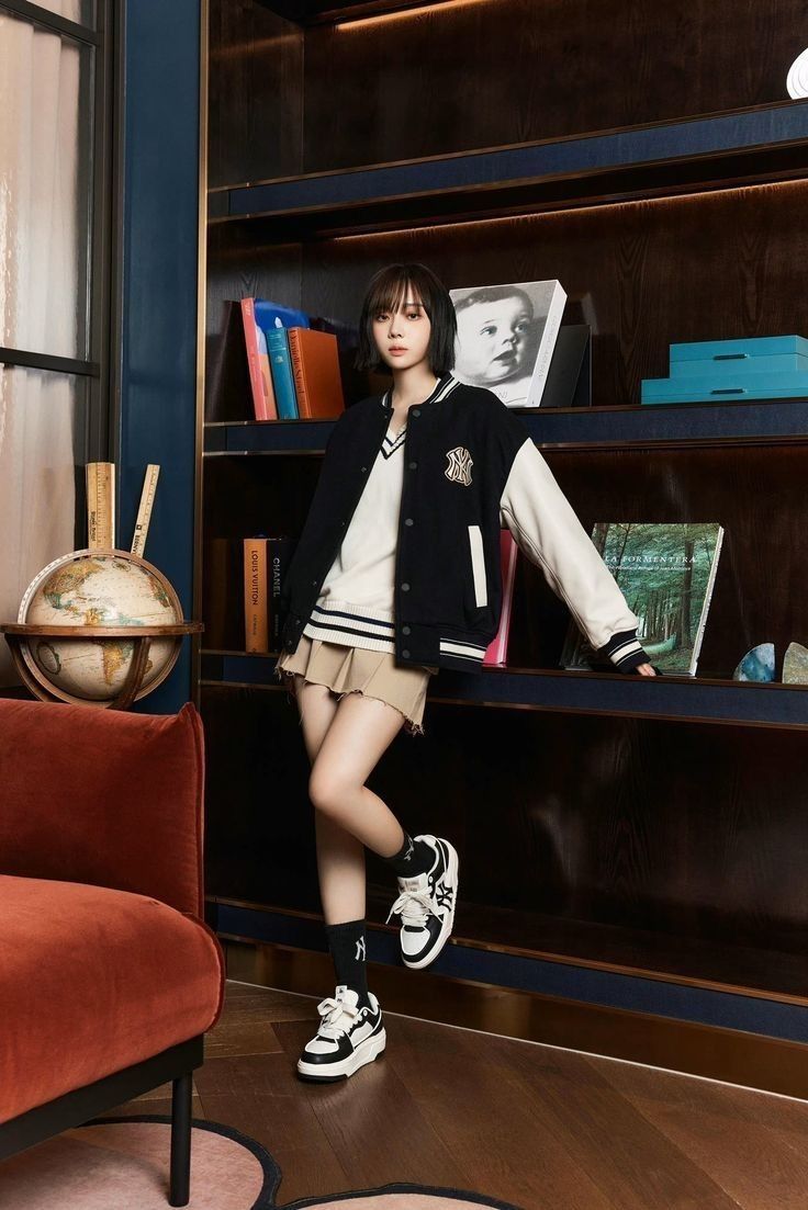 a woman standing in front of a bookshelf