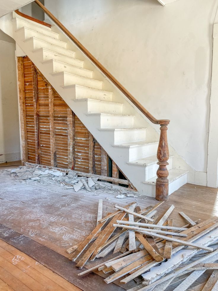 an unfinished room with wooden floors and stairs