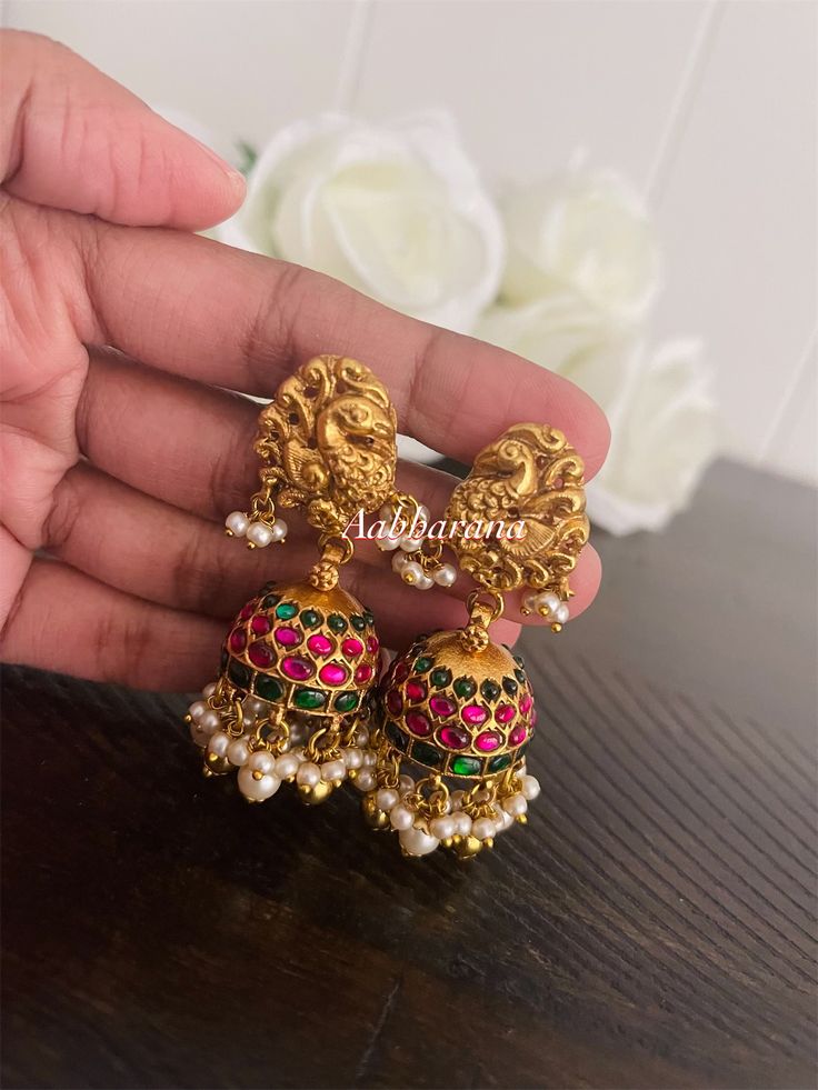 Matte gold finish, peacock design, kundan jadau jumka earrings Earrings length : 2" - screw type **Color may slightly vary due to lighting used in photography Temple Jewelry Peacock Design Jhumkas For Wedding, Wedding Jhumkas With Peacock Design In Temple Jewelry Style, Gold Chandbali Jhumkas With Peacock Design, Temple Jewelry Chandbali Jhumkas With Peacock Design, Temple Jewelry Peacock Design Chandbali Jhumkas, Temple Jewelry Earrings With Peacock Design, Festive Temple Jewelry Earrings With Peacock Design, Gold Kundan Jhumkas With Peacock Design, Temple Jewelry Style Danglers With Peacock Design For Celebration