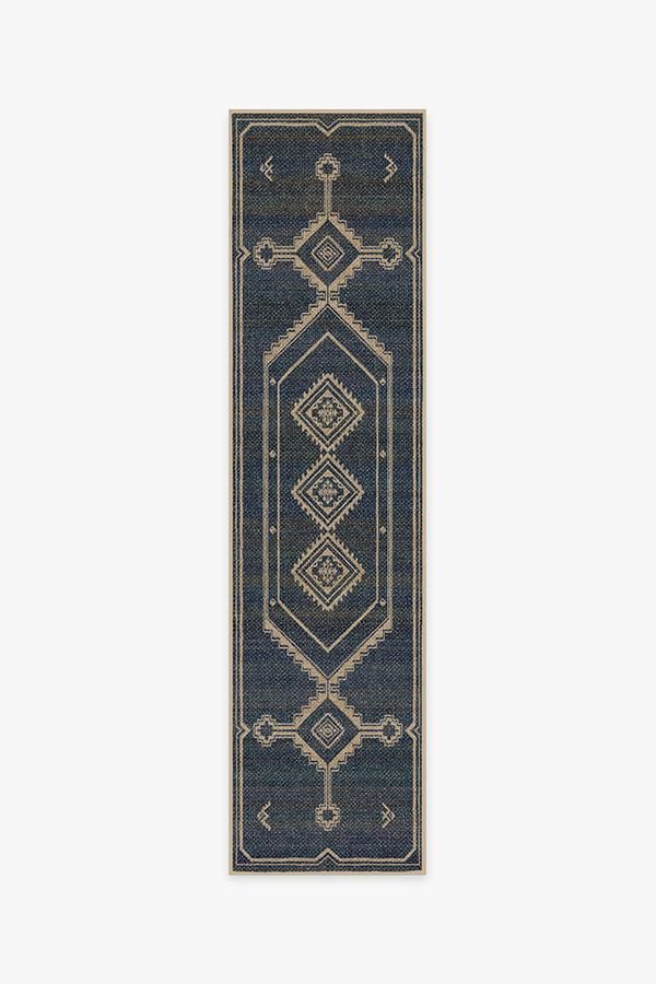 a blue and beige rug with an intricate design on the bottom, in front of a white background