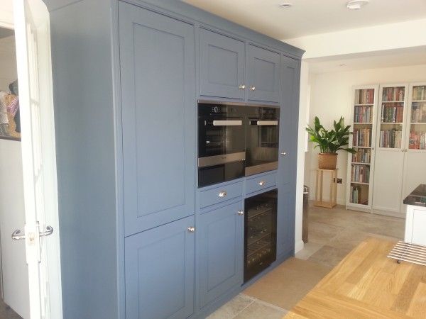 a kitchen with blue cabinets and an oven