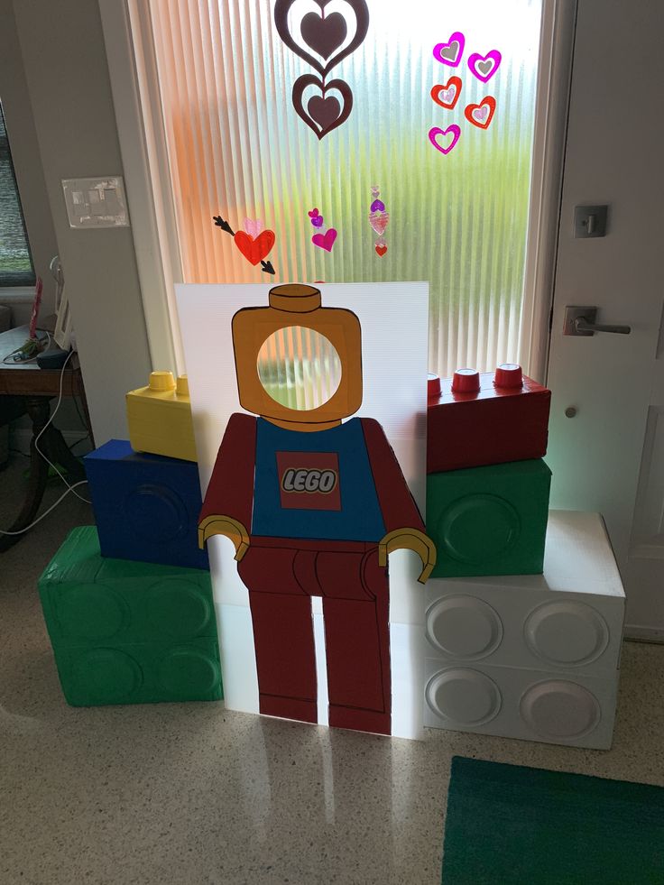 there is a lego man standing in front of a window with hearts on the windowsill