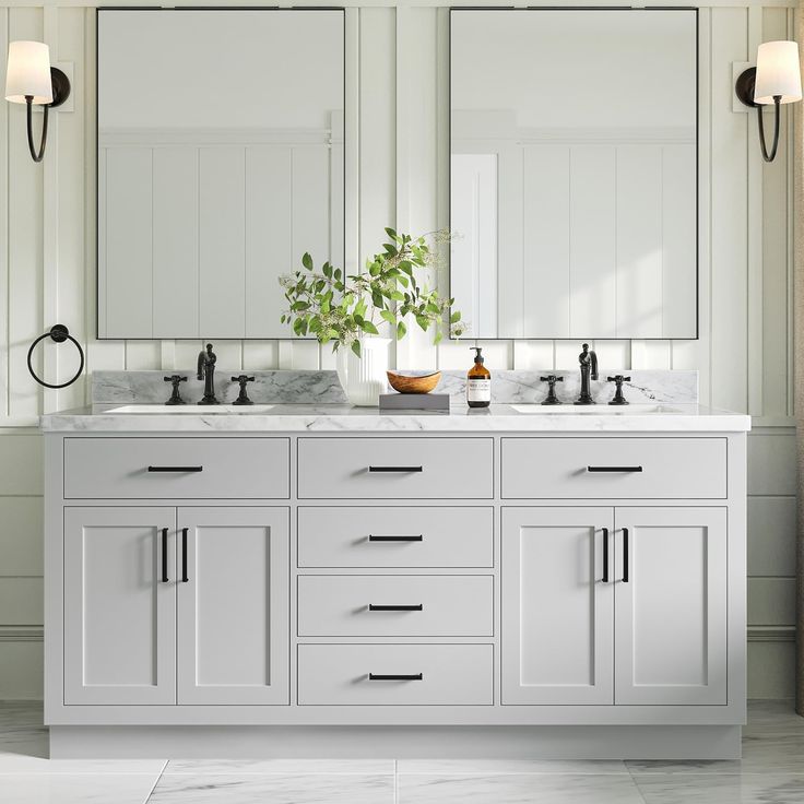 a white bathroom with double sinks and mirrors