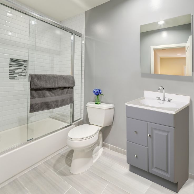 a white toilet sitting next to a walk in shower