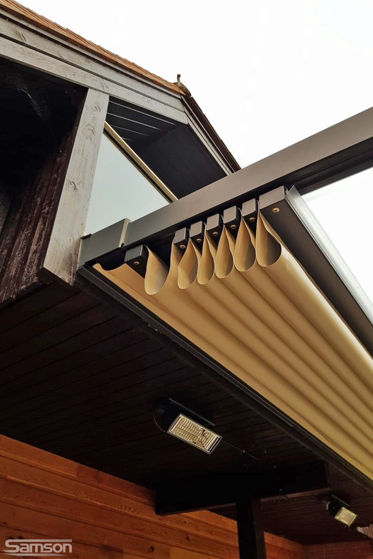 an image of a metal gutter attached to the side of a house with wood siding