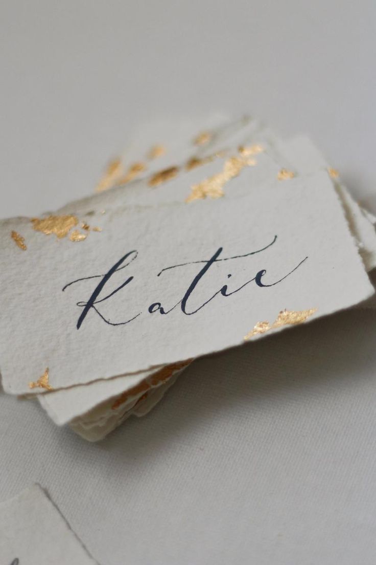 two tags with gold foil on them that say, kaltie and the word