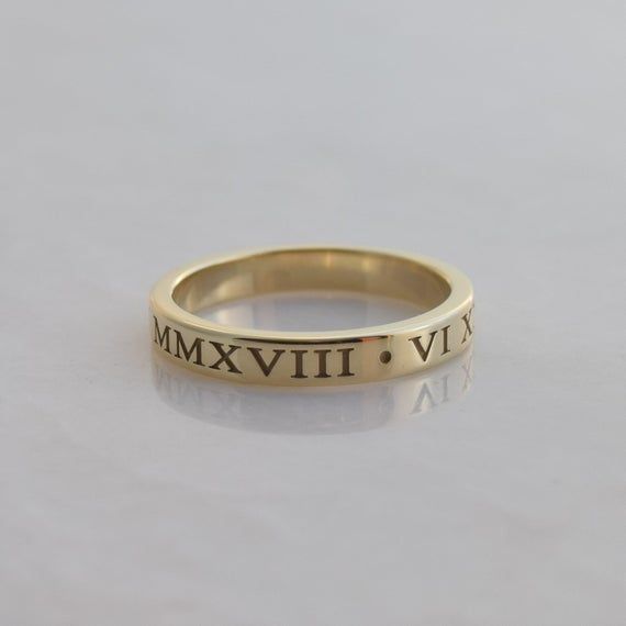 This is a personalized Roman Numeral band in solid 14K gold. The date of your choice is written in Roman Numerals twice around the ring(with a dot separator in between them) Features of the ring:   -Date of your choice is written twice around the band. Or instead, you can choose two  different dates.   -Font is Times New Roman, which is cast right into the ring to give the letters plenty of depth   -Band is 3mm wide and 1.5mm thick.    -Made to order in your size.  - Arrives in a rectangular bla Tiffany Atlas Ring, Roman Numeral Ring, Times New Roman, Ring Ideas, Roman Numeral, Engraved Rings, Roman Numerals, Signet Ring, Anniversary Rings